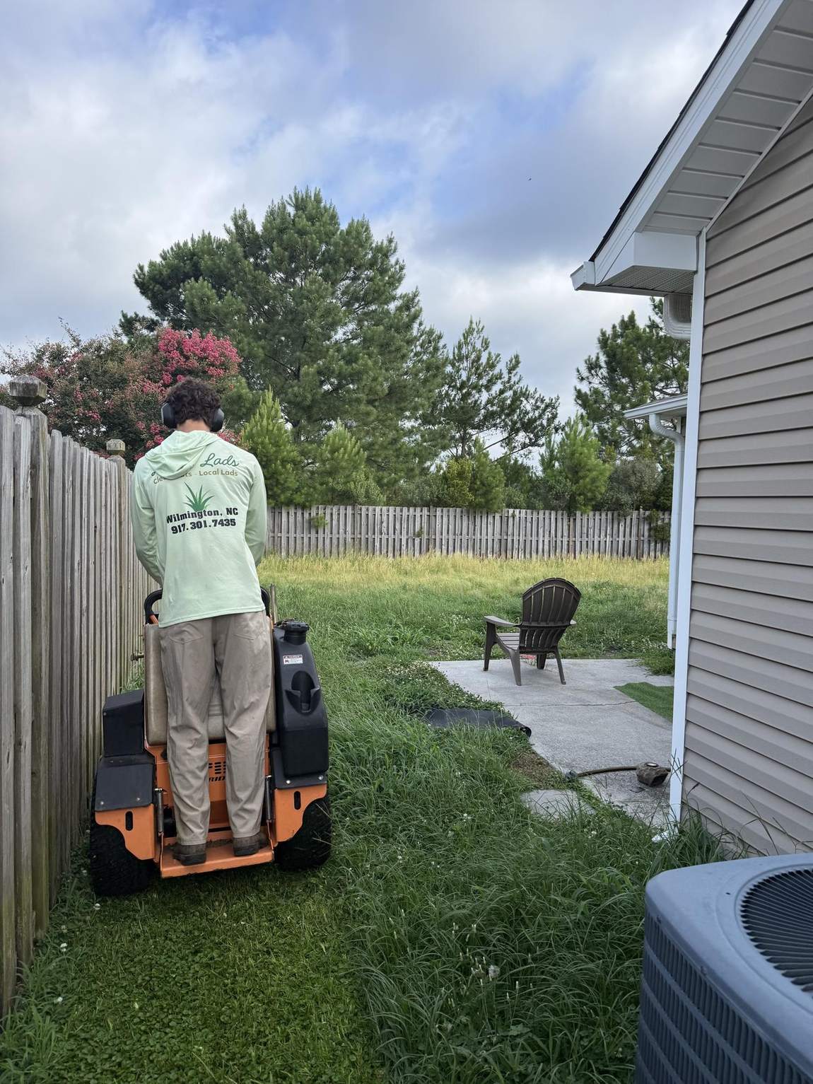 A Lawn Lads founder running a Scag mower on a Wilmington job