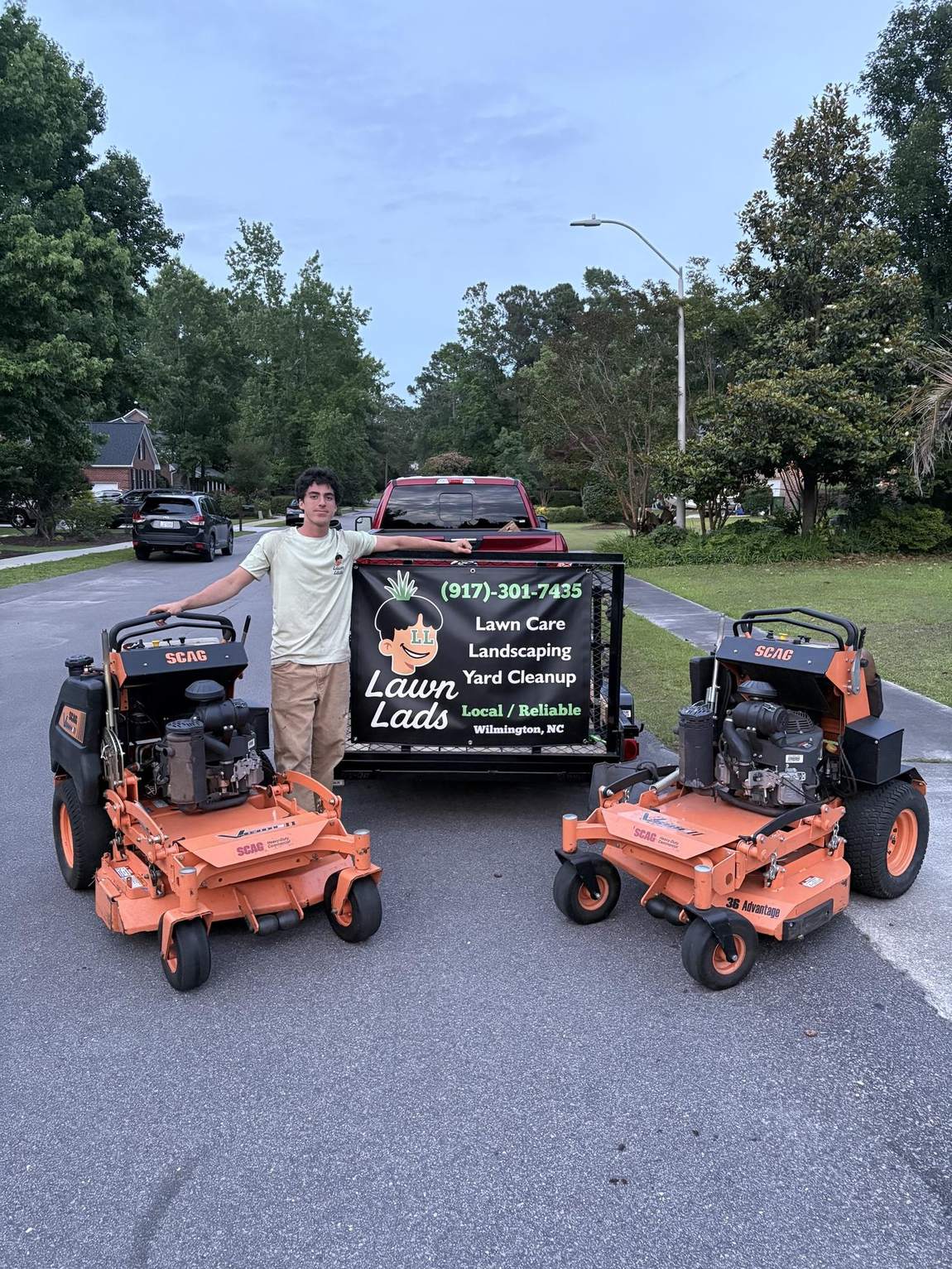 The Lawn Lads crew with their mowers and trailer in Wilmington