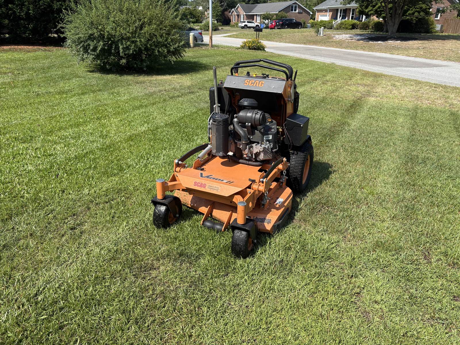 Scag stand-on on a freshly striped lawn
