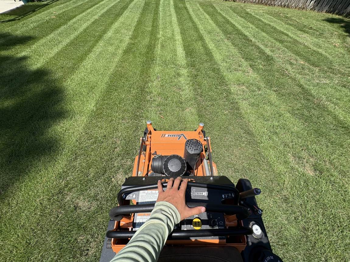 View from the controls of a Scag stand-on laying stripes