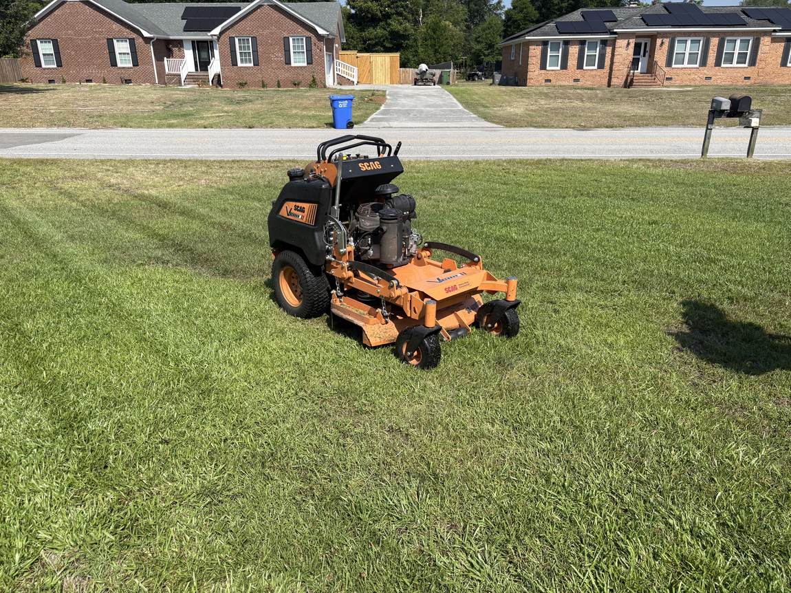 Scag stand-on parked on a finished lawn