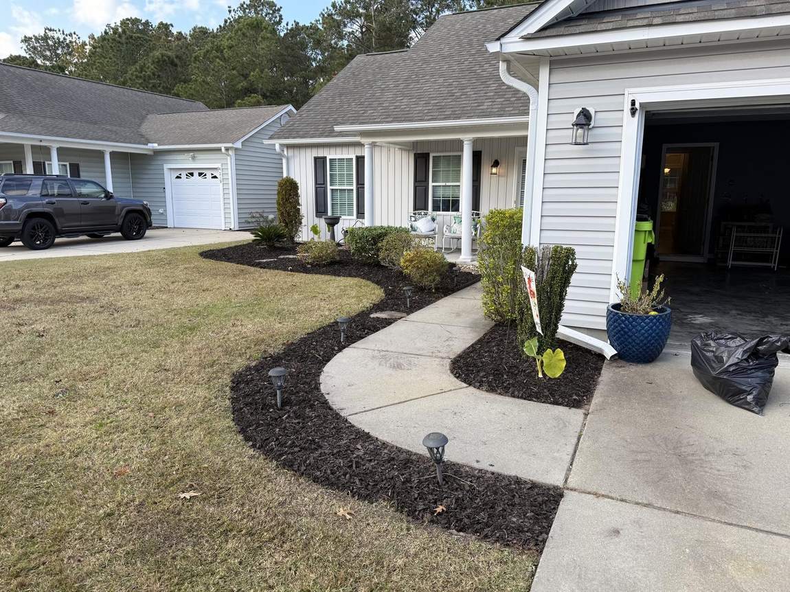 Curved mulch bed following a front walk