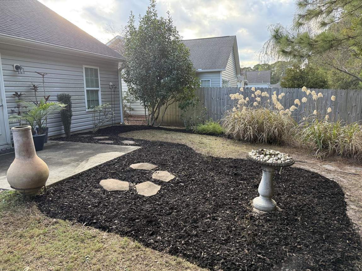 Fresh mulch bed with stepping stones